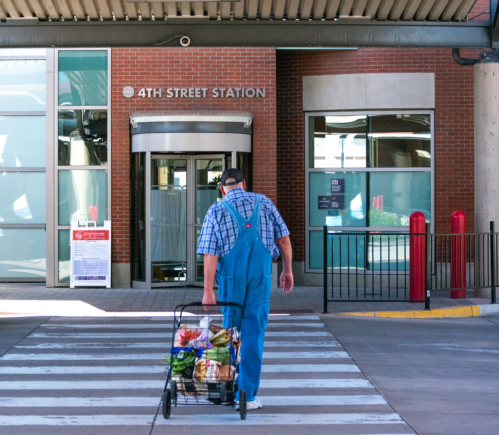 A man with grocery walking at station for availing bus