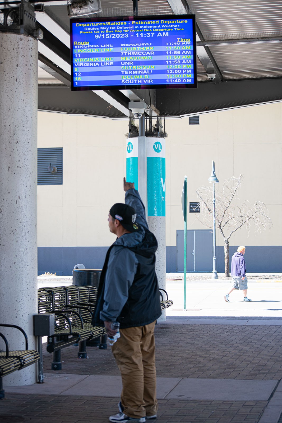 Passenger looking at the bus scheduling board